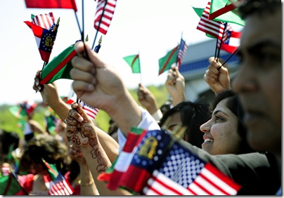 Sannah Vasaya, 18, from Snellville waves flags with other members of the Ismaili community.