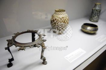 A tripod (L) (Iran, end of the 12th century-begining of the 13th) is presented in the exhibition The Song of the World, 02 October 2007 at the Musee du Louvre in Paris. The exhibition, which takes place from 05 October until 07 January 2008, outlines the evolution of art in Iran under the Safavid Dynasty (1501?1736) presenting a selection of masterpieces from the Aga Khan collection of Islamic art, as a preview to the opening of the Aga Khan Museum in Toronto. AFP PHOTO STEPHANE DE SAKUTIN