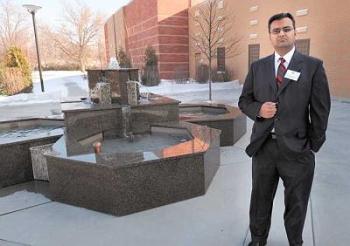 Kabir Kassam, a member of the new Ismaili Jamatkhana, stands by the fountain outside the 26,000-square-foot house of worship and community center in Glenview. The fountain, like many elements, is shaped in a charbagh, Persian for "four gardens," comprised of four heptagons. (Brian O'Mahoney Staff Photographer)