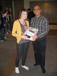 Students receiving a copy of Dictionary of Islam and The Ismailis An Illustrated History for their school library