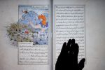 The hand of the photographer rests on a touch-sensitive screen showing the Anvar-i-Suhayli - Lights of Canopus - collection of 15th century fables at the Treasures of the Aga Khan Museum