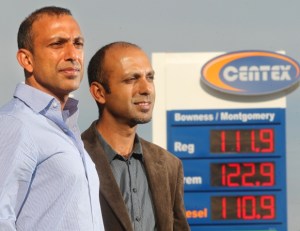 Brothers Alnnor, left, and Shafiq Bhura stand outside one of the their 43 Centex gas outlets