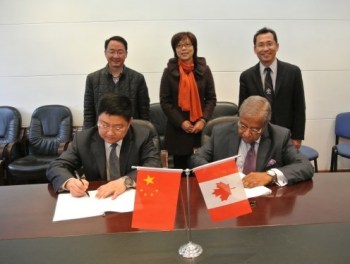 Taj Mitha: BCIT signs training agreements in China Chair of the BCIT Board of Governors, Taj Mitha (seated, right), signs a MOU as Dean of BCIT International Lawrence Gu (standing, right) and members of the Chinese delegation look on.