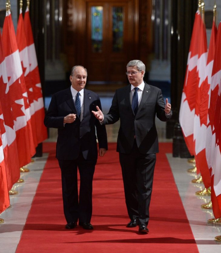 The Aga Khan, spiritual leader of the Ismaili Muslims, walks with Prime Minister Stephen Harper down the Hall of Honour on Parliament Hill in Ottawa on Thursday, Feb. 27, 2014, as they make their way to a signing ceremony. (AP Photo/The Canadian Press, Sean Kilpatrick)
