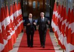The Aga Khan, spiritual leader of the Ismaili Muslims, walks with Prime Minister Stephen Harper down the Hall of Honour on Parliament Hill in Ottawa on Thursday, Feb. 27, 2014, as they make their way to a signing ceremony. (AP Photo/The Canadian Press, Sean Kilpatrick)