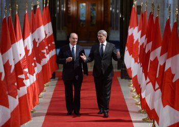 The Aga Khan, spiritual leader of the Ismaili Muslims, walks with Prime Minister Stephen Harper down the Hall of Honour on Parliament Hill in Ottawa on Thursday, Feb. 27, 2014, as they make their way to a signing ceremony. (AP Photo/The Canadian Press, Sean Kilpatrick)