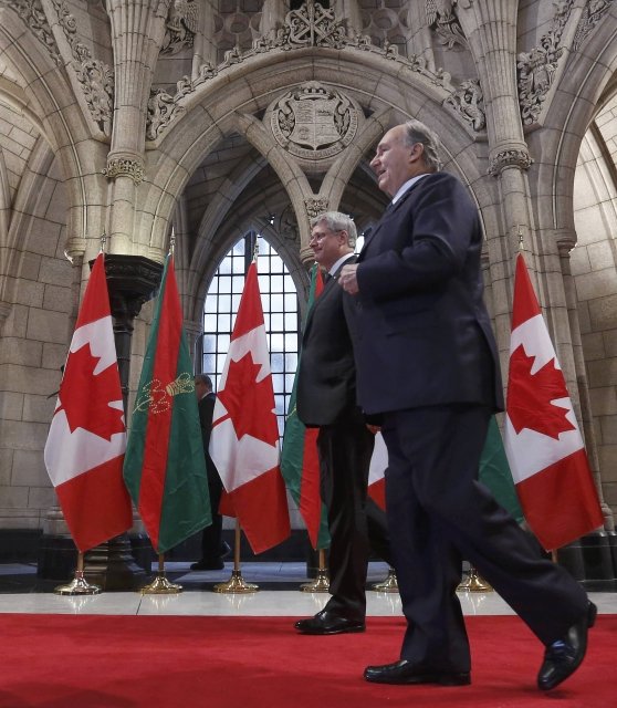 Canada's PM Harper walks with the Aga Khan in the Rotunda on Parliament Hill in Ottawa