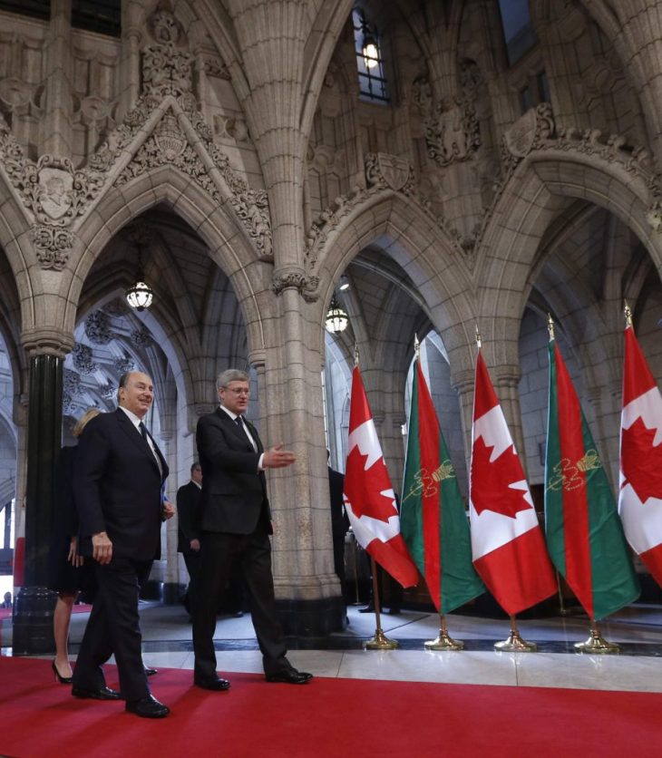 Canada's PM Harper walks with the Aga Khan in the Rotunda on Parliament Hill in Ottawa