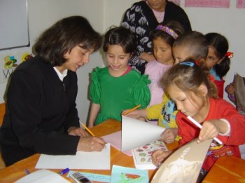 Roshan Thomas helps Afghan children on their first day in Grade 1 at Sparks Academy, a school she founded in Kabul. Thomas was one of nine people gunned down in a Kabul hotel. The photo was taken by Thomas’s son, Karim, who attended Pearson College, along with his sister, Samira.  Photograph by: KARIM THOMAS timescolonist.com