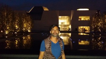 Imran Qureshi takes a break to pose for a picture with the Aga Khan Museum in the background. (Image: Ismailimail/AM)