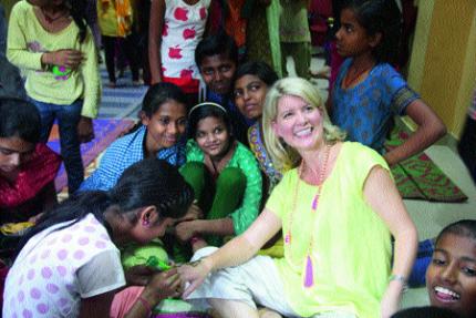 Australia’s ambassador for women and girls Natasha Stott Despoja gets henna put on her hand from a group of young girls. (Image: The Asian Age)