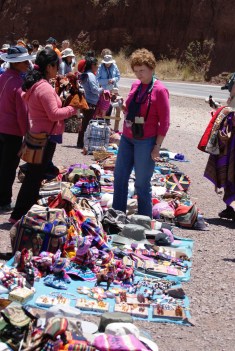 A tourist bargains for souveniors in peru
