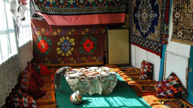 Breakfast time in a Pamiri home There are no hotels in the tiny villages along the Wakhan Valley. Instead, travellers stay in local Pamiri homes, some of which can be found by consulting NGO-organized homestay networks such as Murghab Ecotourism Association or Pamirs Eco-Cultural Tourism Association. The traditional Pamiri house, called a huneuni chid, exhibits symbols of Shia Ismaili Islam, the sect followed by a majority of the Pamiri people. From the outside, their homes appear as simple timbered stone and plaster structures, but inside, they are warm and welcoming. At our homestay in Langar we were served a breakfast of homemade bread and milk tea. Known for their hospitality for centuries, several Pamiri families invited us into their homes as we passed through their villages. We were repeatedly humbled by their offers to drink tea, even though the families had very little themselves. (Audrey Scott)