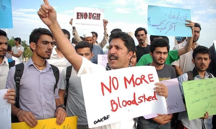 No more bloodshed - Workers of NGOs hold placards as they shout slogans during a protest against the killing of Ismailis outside the National Press Club in Islamabad (Photo: AFP via dawn.com)