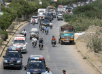 May 13, 2015 Pakistani security personnel escort ambulances carrying the bodies of Ismaili Muslims following the attack in Karachi. (Image credit: Asif Hassan/AFP/Getty Images via The Washington Post)