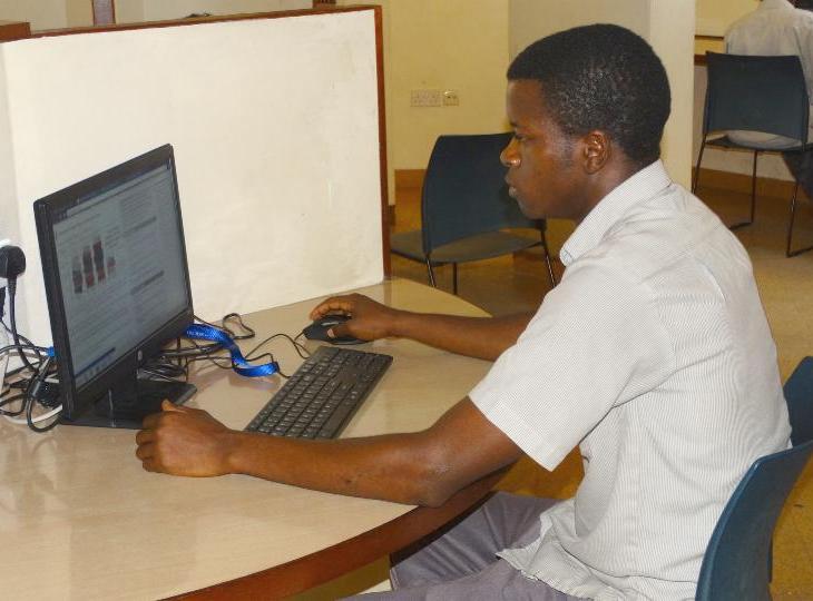 Student at the Aga Khan Academy, Mombasa undertaking his assignments using one of the computers at the school library. (Image via Coastweek)