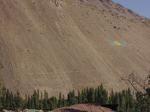 Khorog, Tajikistan: Ismaili flag on the mountain slope
