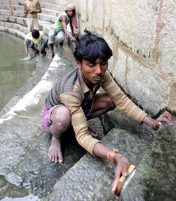 Workers carry out conservation work at Hazrat Nizamuddin Auliyas baoli in New Delhi. (Photograph: Anindito Mukherjee/EPA via The Guardian)
