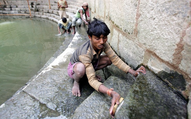 Workers carry out conservation work at Hazrat Nizamuddin Auliyas baoli in New Delhi. (Photograph: Anindito Mukherjee/EPA via The Guardian)