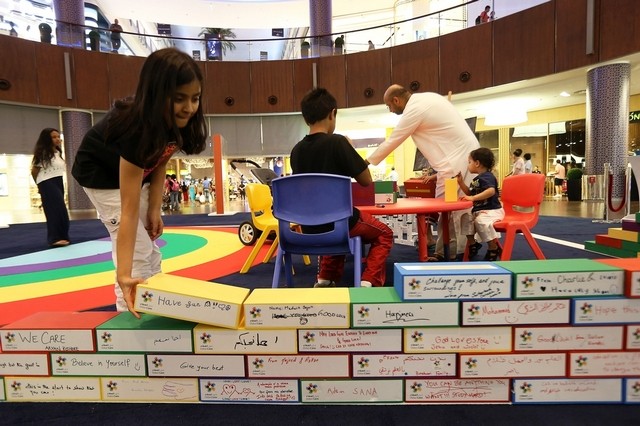 Humza Chaudhry donated a brick to build a wall at Dubai Mall in support of one of Dubai Cares’ many charity projects. (Image credit: Pawan Singh / The National)