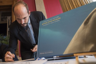 Monaco, November 7-9, 2015: Prince Hussain Aga Khan signing his book, Diving into the Wildlife at the BLUE Ocean Film Festival &amp; Conservation Summit. (Image credit: Monaco Reporter)