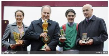 October 5, 2008: His Highness Prince Karim Aga Khan IV, his daughter Princess Zahra, Belgian jockey Christophe Soumillon (2dR) and trainer Alain de Royer Dupre (R) – all pose with trophies after winning the 87th Prix de l’Arc de Triomphe race riding favorite filly Zarkava on at Longchamp racetrack in Paris. Zarkava produced one of the greatest performances in racing history here at Longchamp as she became the first winner to come from stall one since Prince Royale II in 1964 to win the Prix de l’Arc de Triomphe. (Photo by Stephane de Saukutin AFP Photos/Getty Images)