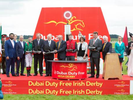 Harzand connections receives the Dubai Duty Free Irish Derby from Colm McLoughlin during the presentation ceremony.