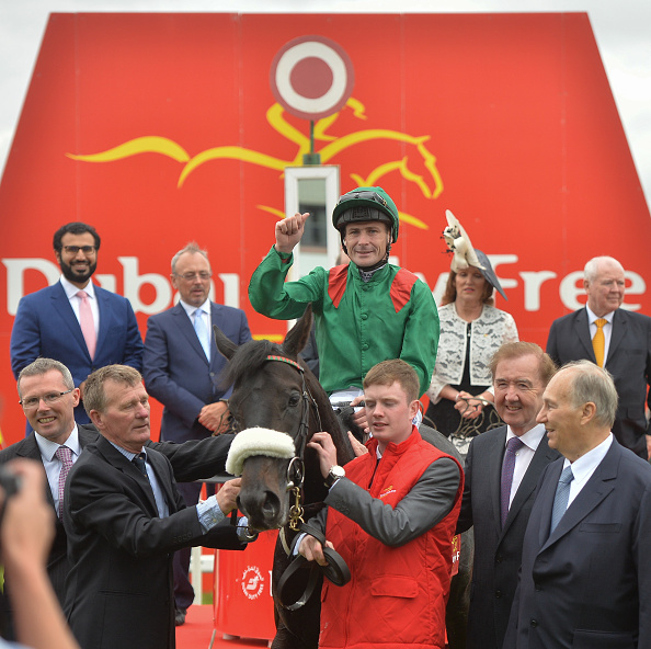 Kildare , Ireland - 25 June 2016; Pat Smullen celebrates on Harzand alongside trainer Dermot Weld, second from right, in the winner's enclosure after the Dubai Duty Free Irish Derby at the Curragh Racecourse in the Curragh, Co. Kildare. (Photo By Cody Glenn/Sportsfile via Getty Images)