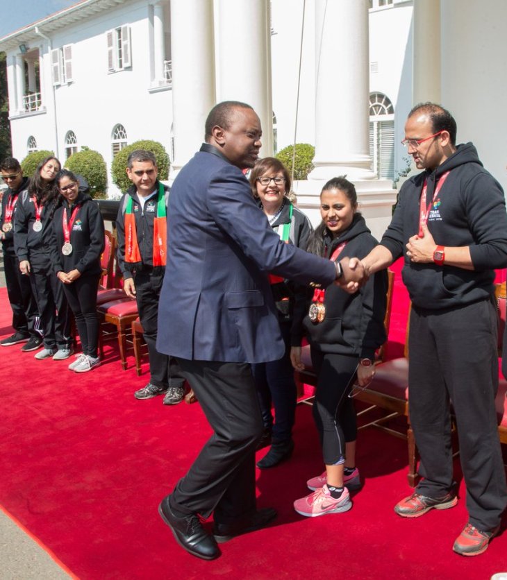 President of Kenya, Uhuru Kenyatta celebrates with medal winning Jubilee Games Team Kenya