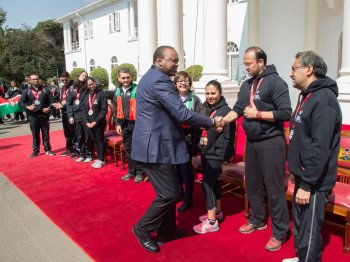 President of Kenya, Uhuru Kenyatta celebrates with medal winning Jubilee Games Team Kenya