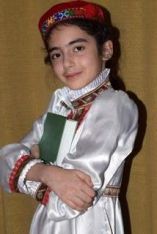 Daughter of Dr. Husniya Dorgabekova, holding a book of Naser-e Khusraw