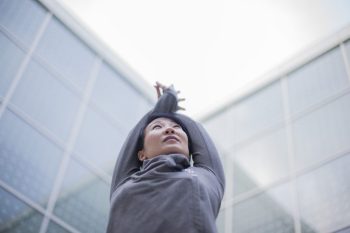 YuMee Chung is a recovering lawyer who teaches yoga in Toronto, demonstrates crescent pose at the Aga Khan Museum. (Image credit: Anne-Marie Jackson via Toronto Star)