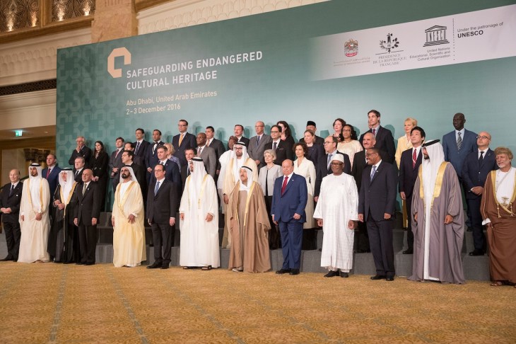 ABU DHABI, UNITED ARAB EMIRATES - December 03, 2016: (front row L-R) HH Prince Aga Khan IV, HH Sheikh Jassim bin Hamad Al Thani Personal Representative of the Emir Qatar, HRH Prince Khalid al Faisal Advisor to the Custodian of the Two Holy Mosques and Governor of Makkah Region, HE Ashraf Ghani President of the Islamic Republic of Afghanistan, HH Sheikh Mohamed bin Rashid Al Maktoum, Vice-President, Prime Minister of the UAE, Ruler of Dubai and Minister of Defence, HE Francois Hollande, President of France, HH Sheikh Mohamed bin Zayed Al Nahyan, Crown Prince of Abu Dhabi and Deputy Supreme Commander of the UAE Armed Forces, HH Sheikh Sabah Al Ahmad Al Jaber Al Sabah Emir of Kuwait, HE Abdrabbuh Mansour, Hadi President of Yemen, HE Ibrahim Boubacar Keita, President of Mali, HE Hailemariam Desalegn Prime Minister of Ethiopia, HH Sheikh Nasser bin Hamad bin Isa Al Khalifa, HE Yusuf bin Alawi bin Abdullah Foreign Minister of Oman (R), (2nd row) HE Alexis Tsipras, Prime Minister of Greece (3rd L), HE Denis Zvizdic, Chairman of the Council of Ministers of Bosnia and Herzegovina (4th L), HE Jack Lang President of Institut du Monde Arabe (5th L), HE Mohamed Khalifa Al Mubarak Chairman of Abu Dhabi Tourism & Culture Authority (6th L), HE Irina Bokova Director General of UNESCO (7th L) and other dignitaries, stand for a photograph during the Safeguarding Endangered Cultural Heritage Conference at Emirates Palace. (Image credit: PRNewsFoto/Abu Dhabi Tourism & Culture Auth)
