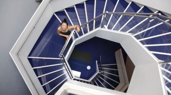 Yoga instructor YuMee Chung ready to demonstrate the 'Upward Spiral' yoga pose inspired by the twirling hexagonal staircase at the Aga Khan Museum. (Image credit: Anne-Marie Jackson via Toronto Star)
