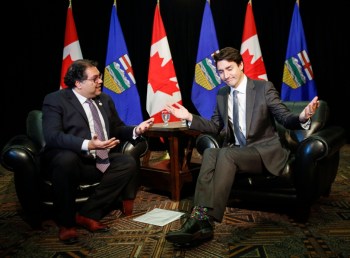 Prime Minister Justin Trudeau, right, meets with Mayor Naheed Nenshi in Calgary during a previous visit to Calgary on Dec. 21, 2016. The pair have been awfully chummy lately, notes Zain Velji. (Jeff McInstosh/The Canadian Press)
