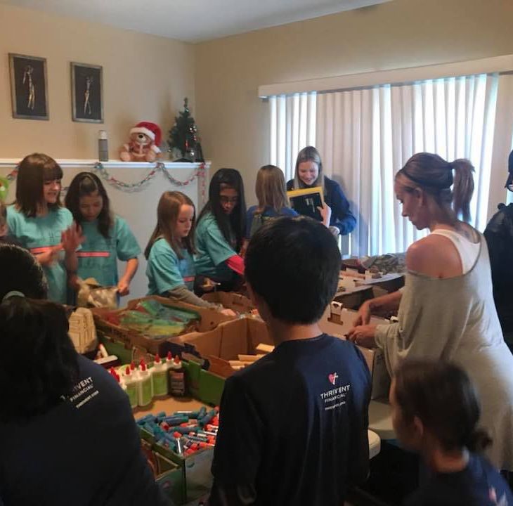 Local girl, volunteers pack bags for homeless children