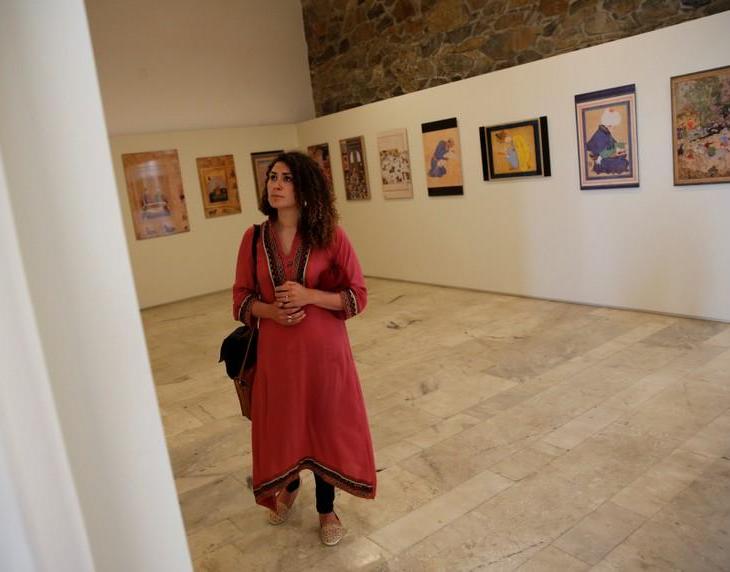 A woman looks at art exhibition at Babur Garden in Kabul, Afghanistan March 31, 2018. Picture taken March 31, 2018. REUTERS/Mohammad Ismail