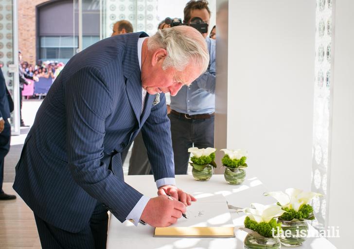 HRH The Prince of Wales signs the guest book during the inauguration of the Aga Khan Centre in London. 26 June 2018. Photo: The.Ismaili / ANYA CAMPBELL