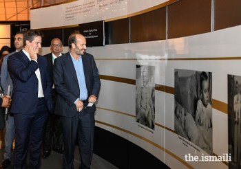Prince Hussain and Prince Aly Muhammad admire a photograph of Mawlana Hazar Imam as a young boy, during their tour of the Rays of Light exhibition at the Diamond Jubilee Celebration in Lisbon.AZIZ AJANEY