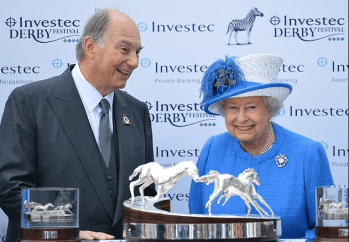 Surrey, England. June 4, 2016: His Highness Prince Karim Aga Khan IV speaks with Queen Elizabeth II after his horse Harzand won the Derby on the second day of the Epsom Derby Festival. The Derby Day at the Investec Derby Festival was celebrating the Queen's 90th birthday at Epsom Downs Racecourse. Image credit: AFP via Getty Images
